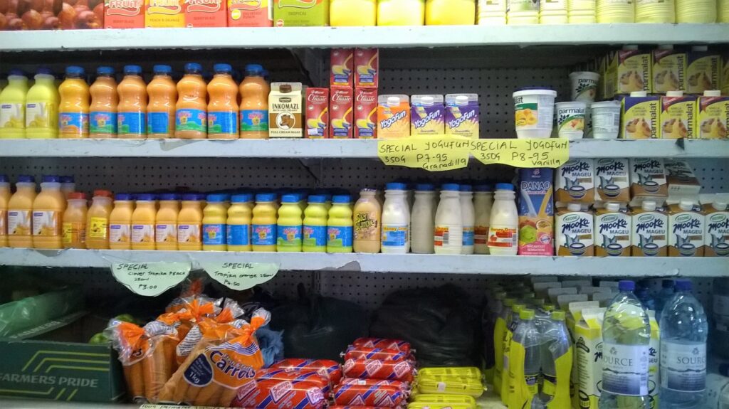 yellow and white plastic bottle on yellow shelf